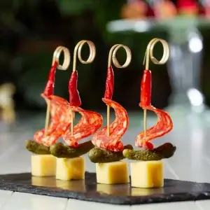 Gourmet Grilled Cheese Bites pintxos with pepper served elegantly on black platter