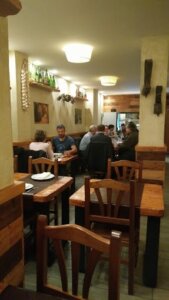 Best Restaurant for Business Meetings: Cozy dining space with people enjoying meals and conversations.